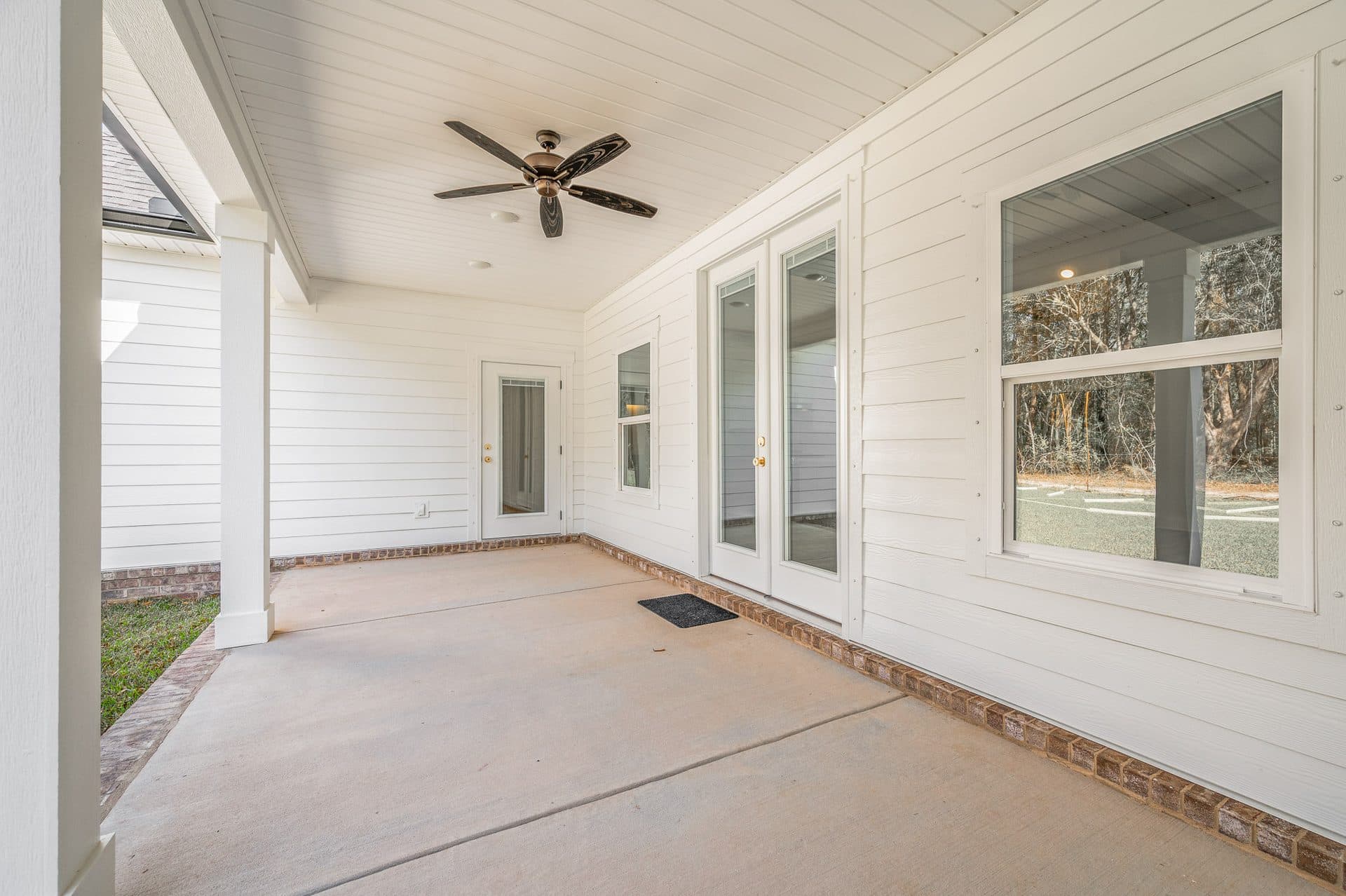 The Cameron covered back porch with a tongue-and-groove ceiling and French doors
