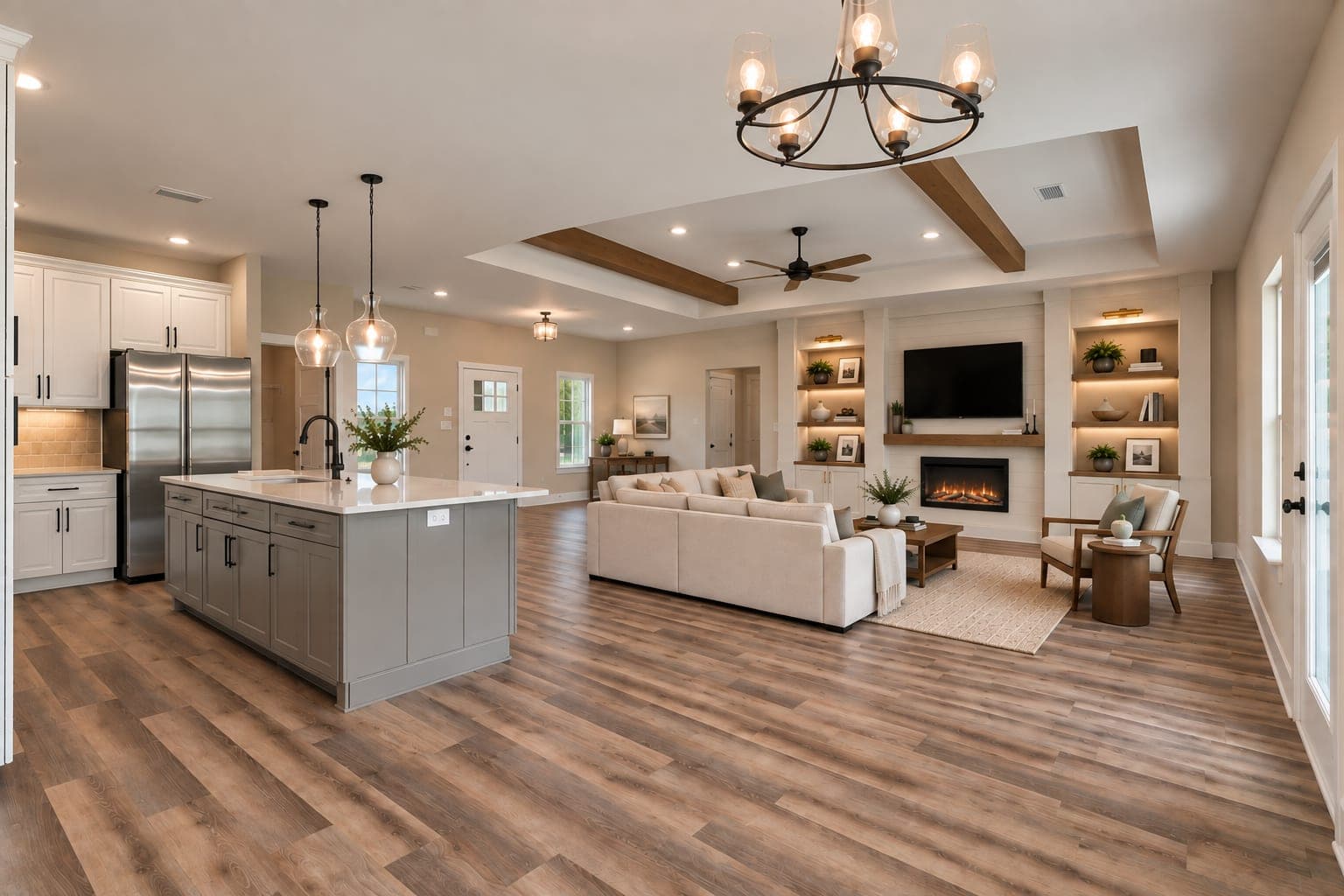 Rendering of the living room in the Lunsford, showing a tray ceiling with exposed wood beams, a fireplace with built-in shelving, and a large kitchen island beyond.
