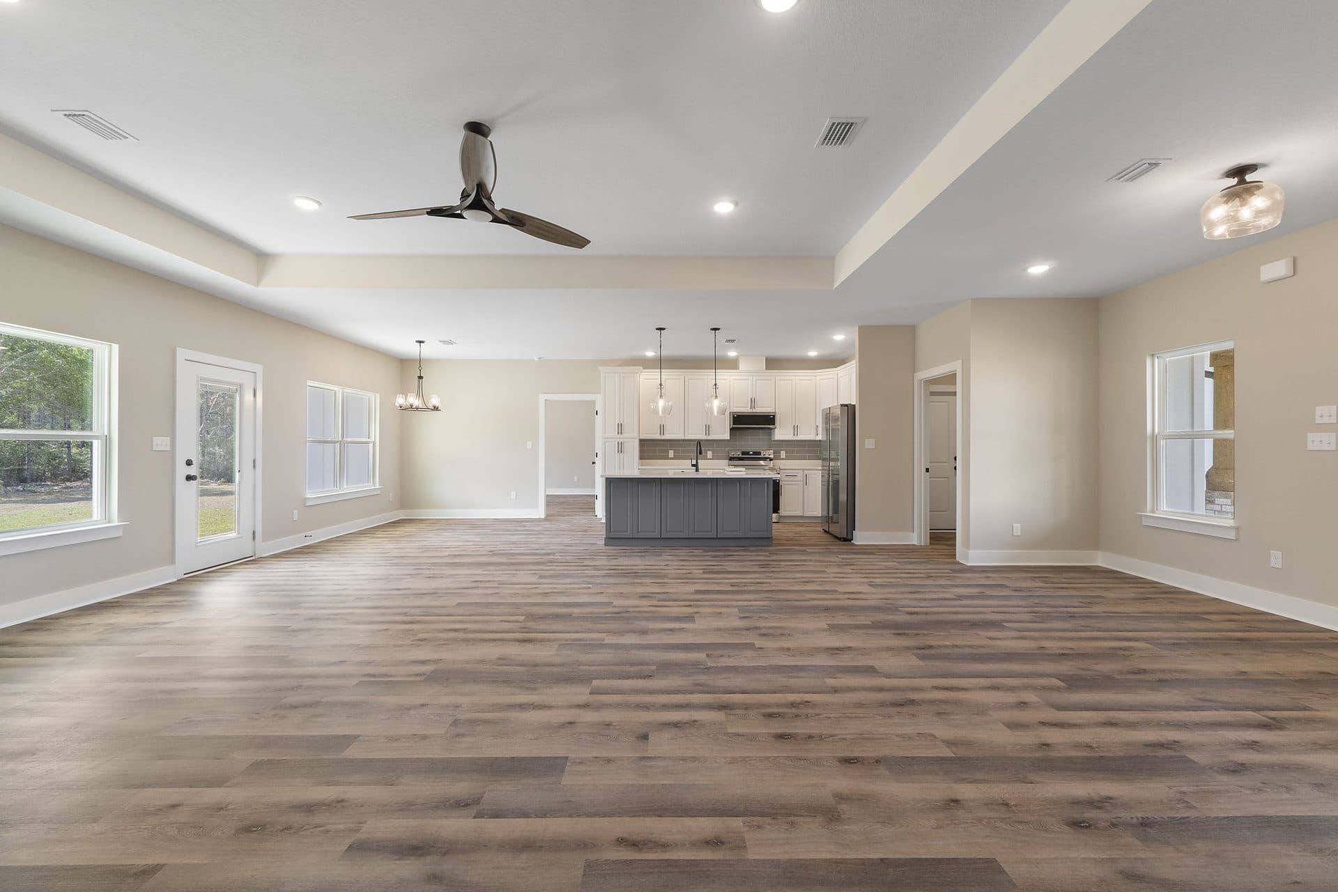 Great room of a finished Lunsford under a long tray ceiling